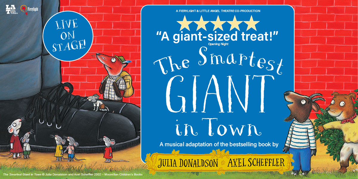 A giant wearing a patchwork suit stands in a colourful town, surrounded by various animals.