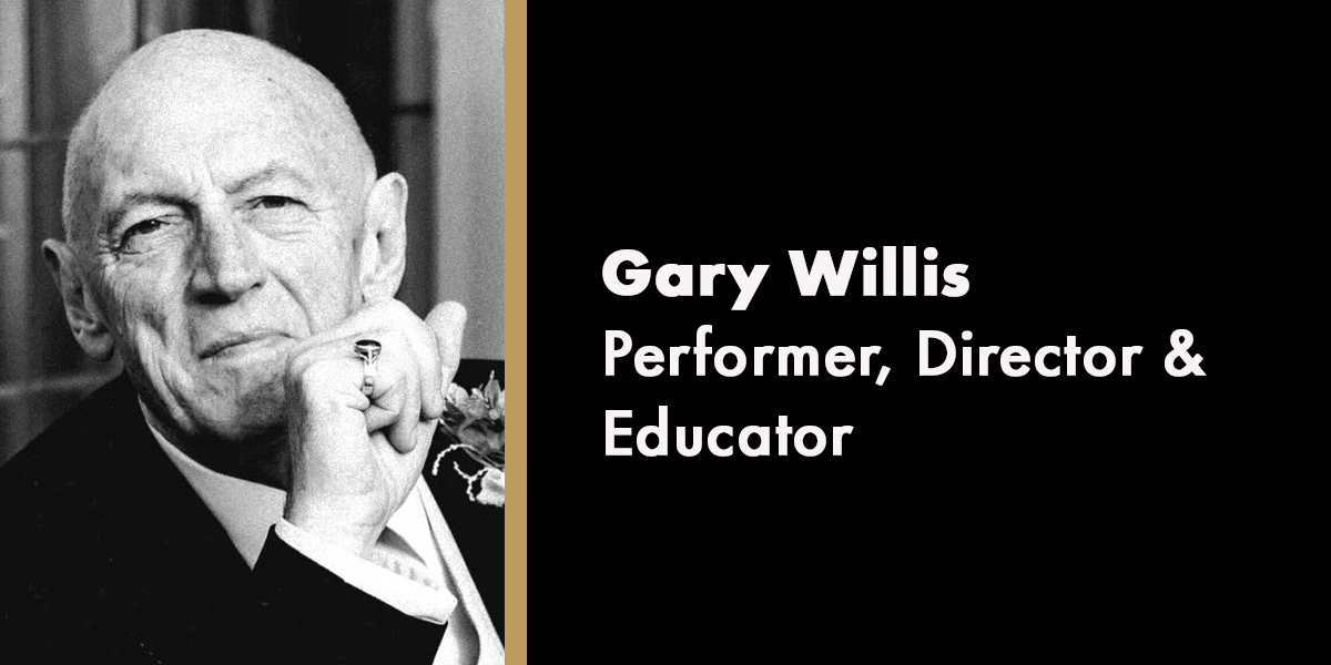 A portrait of Gary Willis, smiling, with a dark background and a subtle light highlighting his features.