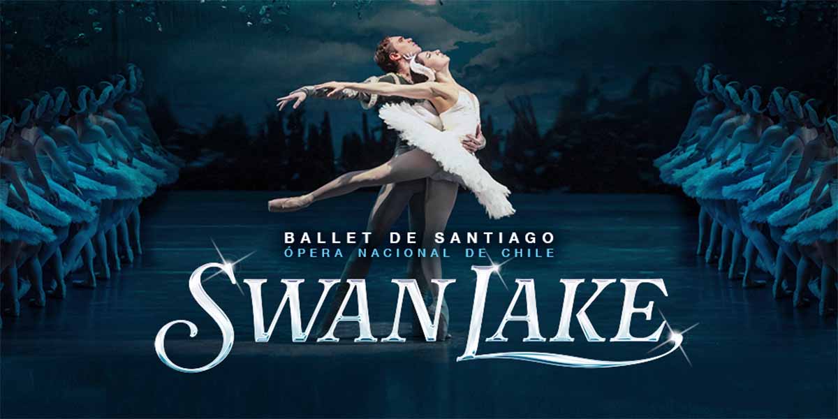Two ballet dancers perform a graceful pose, surrounded by dancers in white tutus.